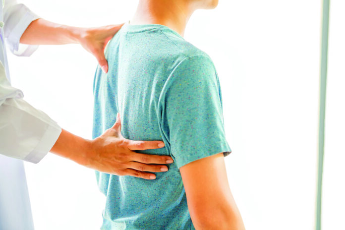 Close up of Physiotherapist working with patient in clinic Kaizen