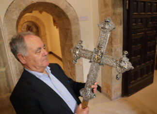 Brágimo - El delegado de Patrimonio Cultural de la Diocesis de Palenica, José Luis Calvo, sujeta la cruz procesional que fue escondida por el párroco de Quintana del Puente (Palencia) durante la invasión francesa de la península, y apareció durante las labores de restauración de la iglesia de San Esteban