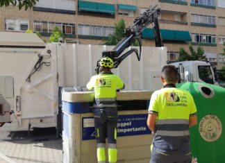 Operarios de Palencia Deslumbra recogiendo esta tarde los contenedores de cartón en la zona de Cardenal Cisneros. / Óscar Herrero